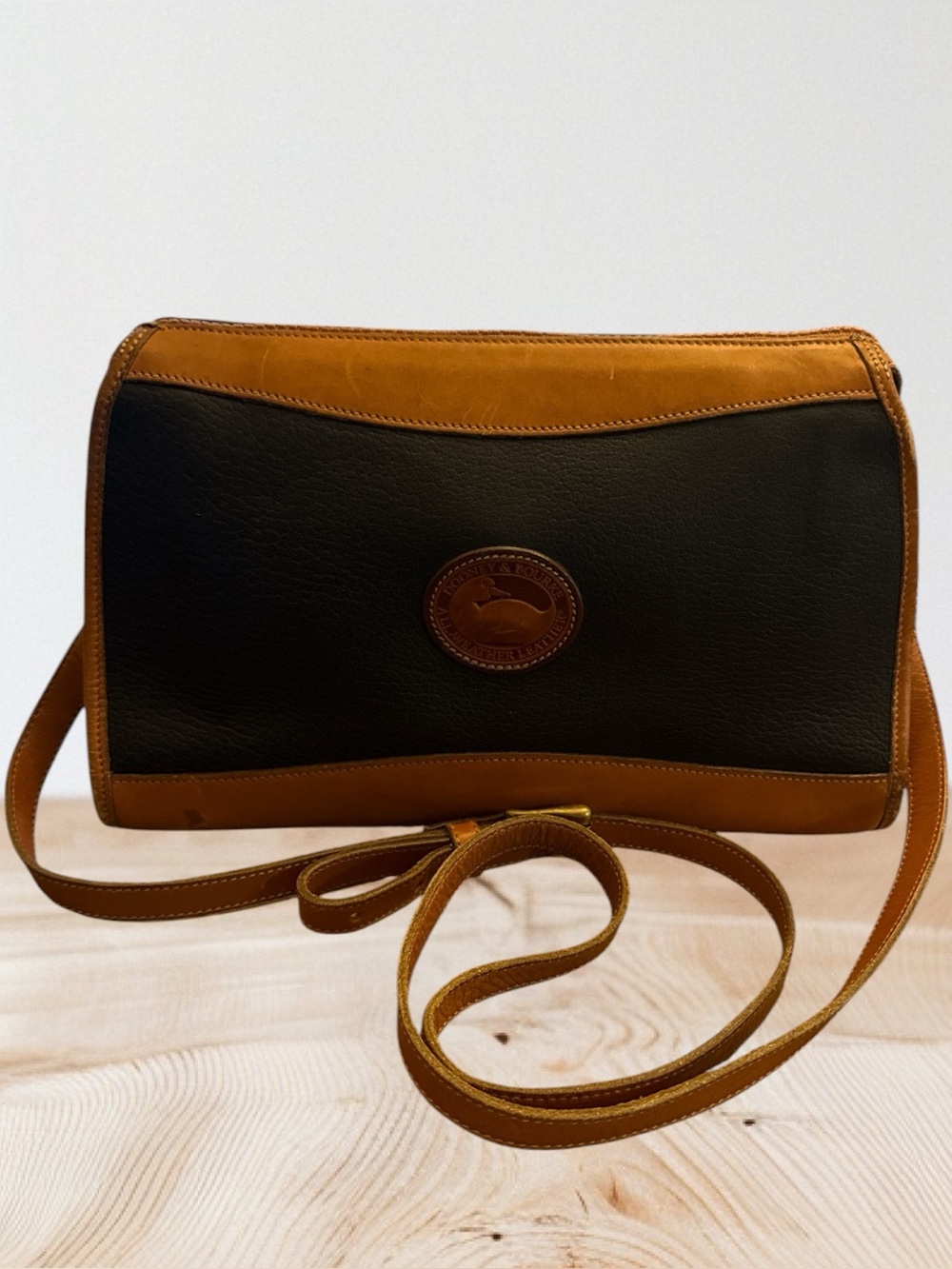 Vintage Dooney & Bourke All-Weather Leather Crossbody Bag In Black And Tan.